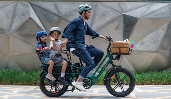 A man rides a Fiido T2 electric bicycle with two children